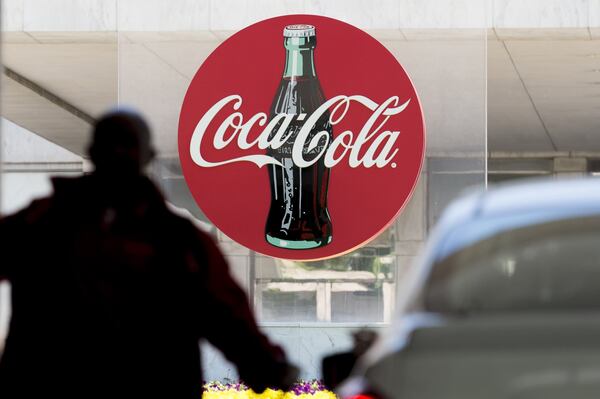 A parking attendant helps a guest at the Coca-Cola headquarters main entrance in Atlanta, Georgia, on Tuesday, April 25, 2017. (DAVID BARNES / DAVID.BARNES@AJC.COM)