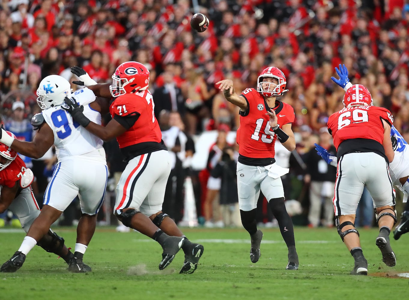 Georgia quarterback Carson Beck throws a touchdown pass to wide receiver Marcus Rosemary-Jacksaint to take a 7-0 lead over Kentucky during the first quarter in a NCAA college football game on Saturday, Oct. 7, 2023, in Athens.  Curtis Compton for the Atlanta Journal Constitution