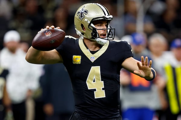 New Orleans Saints quarterback Derek Carr (4) works in the pocket against the Atlanta Falcons during the second half of an NFL football game, Sunday, Nov. 10, 2024, in New Orleans. (AP Photo/Butch Dill)