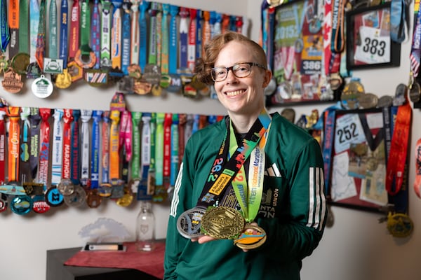 Caroline Burnet poses for a portrait at her home in Atlanta on Friday, February 28, 2025. Burnet will be running her 200th marathon. (Arvin Temkar / AJC)