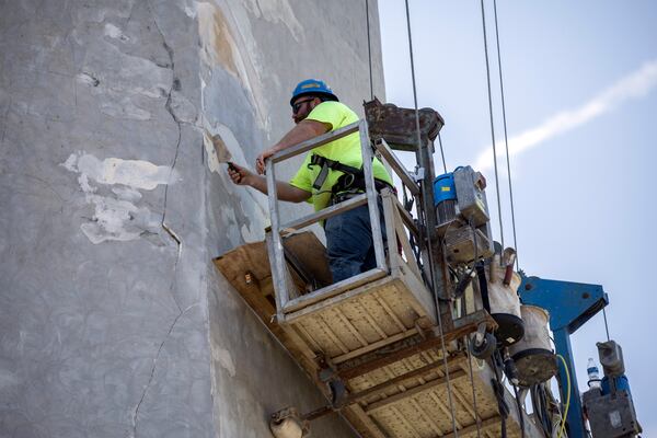 Roy Fischer, foreman on the project with ICC Common Wealth, uses a trawl to fill a void with stucco on the 145-foot tall lighthouse on Tybee Island on May 23, 2024. Tybee Island Historical Society is spending $1.8 million to replace the roof, the glass around the navigation light and the masonry. (AJC Photo/Stephen B. Morton)