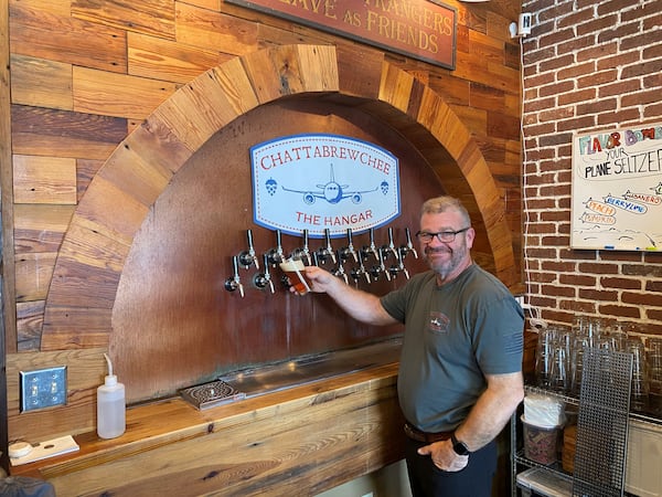 Chattabrewchee Southern Brewhouse owner Beau Neal pours a pint at the Hangar brewery in Hapeville. (Bob Townsend for The Atlanta Journal-Constitution)