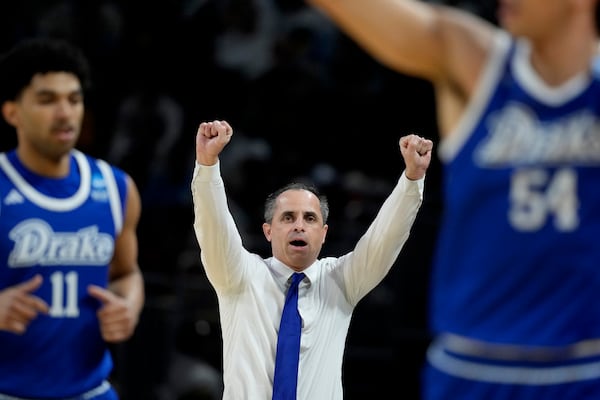 Drake head coach Ben McCollum talks to his players during the first half of the first round against Missouri of the NCAA college basketball tournament, Thursday, March 20, 2025, in Wichita, Kan. (AP Photo/Charlie Riedel)