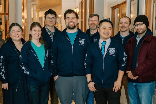 Jam & Tea Studios founders, left to right, Michael Yichao, center, Carl Kwoh, third from right, and J. Aaron Farr, fourth from right, pose with staff on Jan. 18, 2024, in Roslyn, Wash. (Lutisha Aubrey Photography via AP)