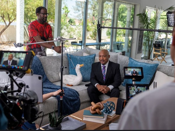 Raymond Carr (left) controls the Aflac duck puppet with "Shark Tank" co-host and investor Daymond John. (Courtesy of Aflac Production)