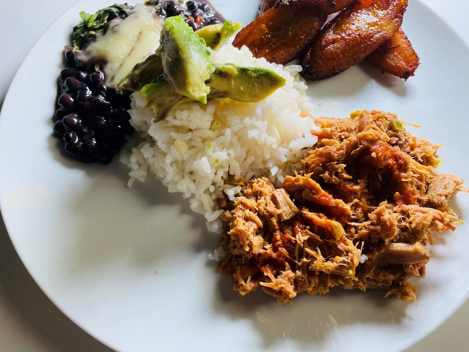 Pabellon criollo includes shredded beef with rice, black beans and sweet plantains. Bob Townsend for The Atlanta Journal-Constitution