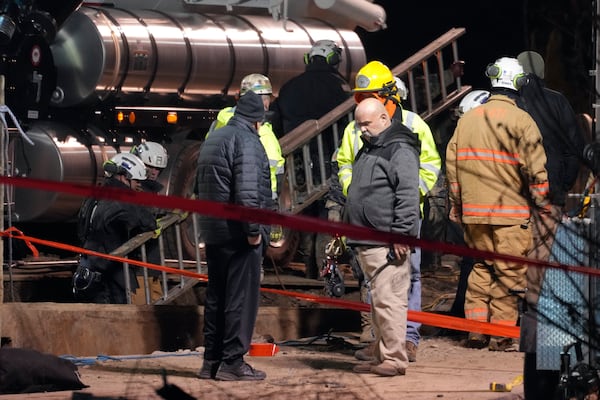 Rescue workers clear their equipment in order to take a different approach to their search for Elizabeth Pollard, who disappeared while looking for her cat in Marguerite, Pa., Wednesday, Dec. 4, 2024. (AP Photo/Gene J. Puskar)