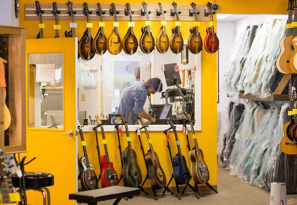 Maple Street Guitars in Buckhead is a mainstay for guitar lessons, all their teachers continue to provide lessons online and classes are available for new students to join Tuesday, April 14, 2020. Lindsay Petsch, the store manager, continues to take calls and repairs. (Jenni Girtman/Atlanta Journal-Constitution)