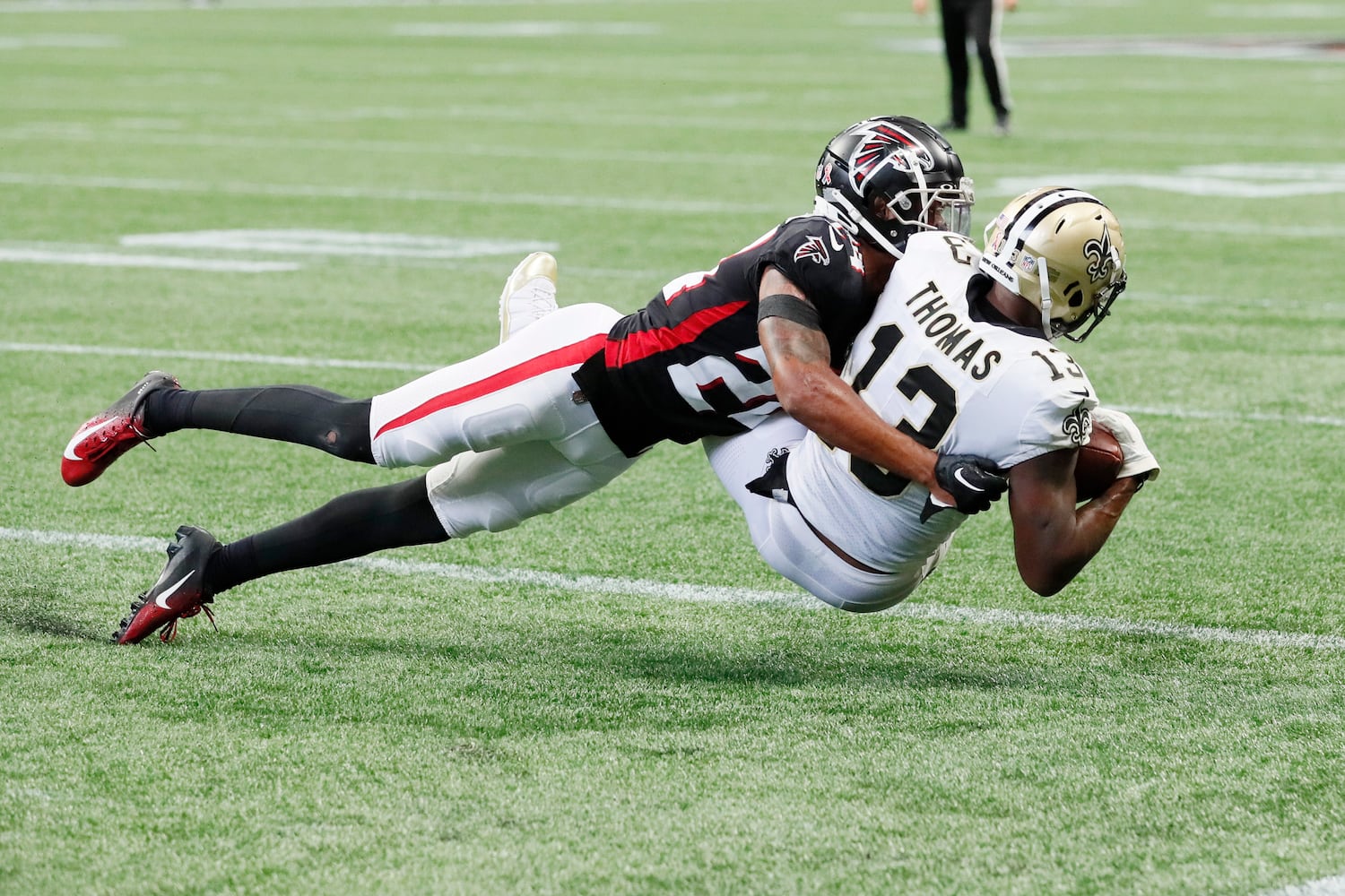 Saints wide receiver Michael Thomas catches a touchdown pass while being covered by Falcons cornerback A.J. Terrell in the fourth quarter Sunday. (Miguel Martinez / miguel.martinezjimenez@ajc.com)