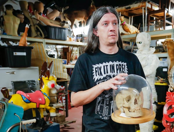 Set decorator Nick Morgan moves items around in order to sort through the space at the Obscure Prop House in Chamblee on Wednesday, July 26, 2023. (Katelyn Myrick/katelyn.myrick@ajc.com)