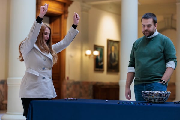 Leigh Combs, elections services manager in the elections division of the Georgia secretary of state's office, rolls a die Wednesday in the state Capitol. The dice roll was used to select ballot batches that will be pulled in all 159 Georgia counties for a statewide election audit. (Arvin Temkar / arvin.temkar@ajc.com)