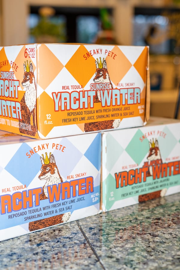 Six-packs of Yacht Water's three different flavors — Original, Jalapeño and Sunrise — are displayed.