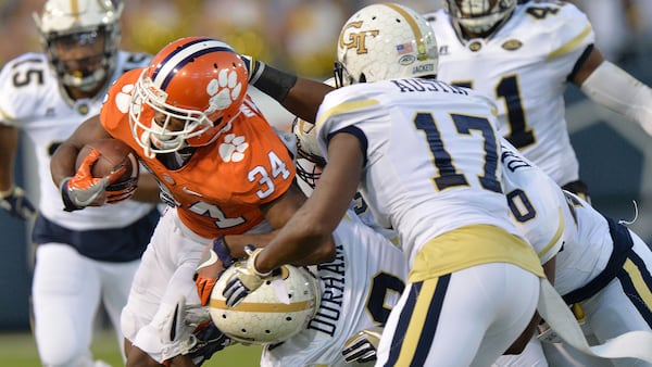 Georgia Tech Yellow Jackets defensive back Step Durham (8) and Lance Austin (17) collaborate on a tackle against Clemson Thursday, Sept. 22, 2016, at Bobby Dodd Stadium in Atlanta.