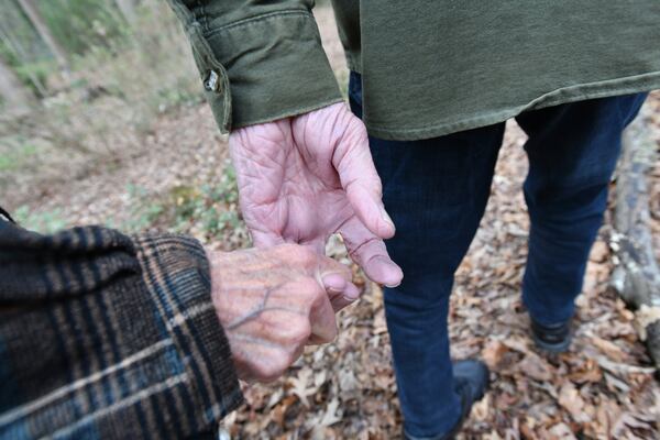 Sandy Krause holds a hand of her husband, Rick Krause, in the backyard of their home in Lilburn on Tuesday, March 10, 2020. Rick is caregiver for Sandy, who has Alzheimer’s disease. HYOSUB SHIN / HYOSUB.SHIN@AJC.COM