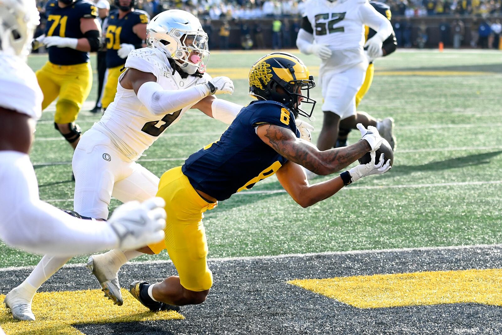 Michigan wide receiver Tyler Morris (8) hauls in a catch past Oregon defensive back Brandon Johnson (3) in the first half of an NCAA college football game, Saturday, Nov. 2, 2024, in Ann Arbor, Mich. (AP Photo/Jose Juarez)