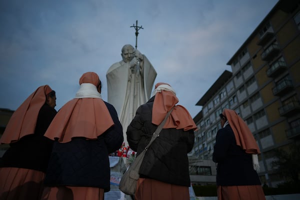 Nuns pray for Pope Francis in front of the Agostino Gemelli Polyclinic, in Rome, Saturday, March 8, 2025, where the Pontiff is hospitalized since Friday, Feb. 14. (AP Photo/Andrew Medichini)