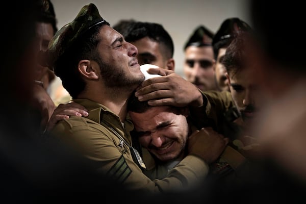 Israeli Defense Forces soldiers mourn at the grave of Sgt. First Class (res.) Roi Sasson, who was killed in action in the Gaza Strip, during his funeral at Mt. Herzl military cemetery in Jerusalem, Wednesday, Nov. 20, 2024. (AP Photo/Maya Alleruzzo)