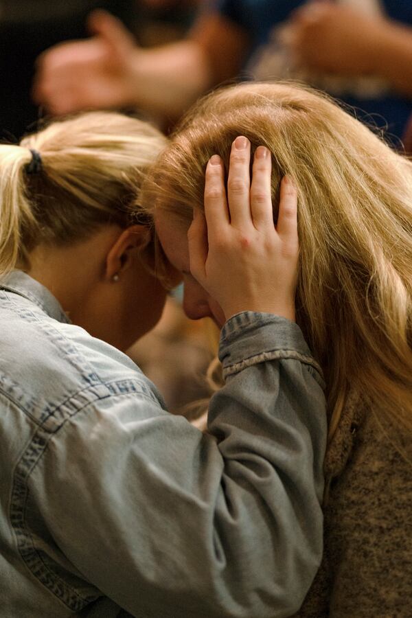 Two women pray at Hughes Chapel on the campus of Asbury University in Wilmore, Ky., on Feb. 18, 2023. Many people say they had intense personal experiences during the revival. (Jesse Barber/The New York Times)