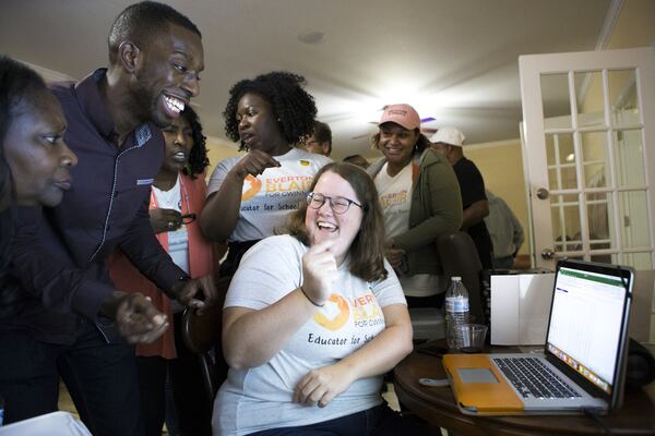 Everton “EJ” Blair, Jr. (left), candidate for Gwinnett County Board of Education District 4, celebrates with his campaign manager, Chelsea Kearns, as they look at voting results in his favor from precincts in the Shiloh district, during an election night watch party at his home in Snellville on Tuesday, Nov. 6, 2018. (Casey Sykes for The Atlanta Journal-Constitution)