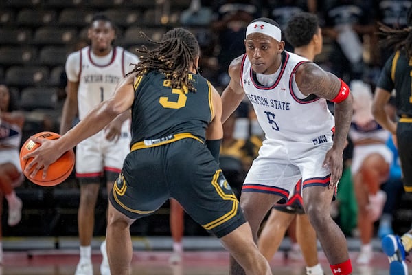 Jackson State guard Keiveon Hunt (5) defends against Alabama State guard CJ Hines (3) during the first half of an NCAA basketball game in the championship of the Southwest Athletic Conference Championship tournament Saturday, March 15, 2025, in College Park, Ga. (AP Photo/Erik Rank)