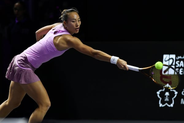 China's Qinwen Zheng returns the ball during her women's singles semifinal match against Czech Republic's Barbora Krejcikova at King Saud University Indoor Arena, in Riyadh, Saudi Arabia, Friday, Nov. 8, 2024. (AP Photo)