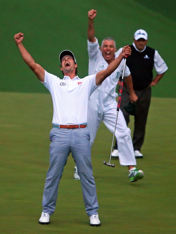 My favorite photo of the year. After covering the Masters for more than 25 years it was nice to be in the right place at the right time to make one of my best Masters moments. Photographers and fans have to make their way down the hill from the 18th green to the 10th green for the second playoff hole (which turns into somewhat of a mad dash despite the strickly enforced walking only policy). The first photographers to arrive can get a spot on the photo tower overlooking the green, which I was able to accomplish. It was getting very dark when the photo was made with a Canon EOS-1DX, A 70-200MM F2.8 lens at F3.5, and a ISO rating of 10,000. 041413 AUGUSTA: Adam Scott and his caddy Steve Williams react to the putt dropping on the second playoff hole on the 10th green to win the Masters on Sunday, April 14, 2013, in Augusta. Runner up Angel Cabrera looks on in the background. It is Scott's first major. CURTIS COMPTON/ CCOMPTON@AJC.COM