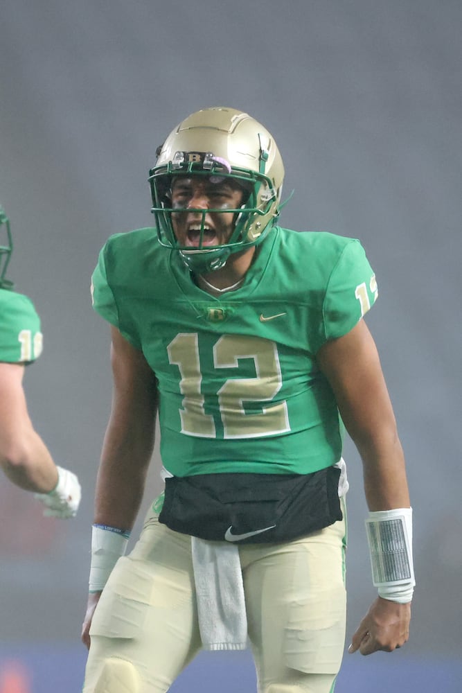 Buford quarterback Ashton Daniels celebrates his touchdown pass to wide receiver Tobi Olawole (not pictured) during the fourth quarter against Langston Hughes in the Class 6A state title football game at Georgia State Center Parc Stadium Friday, December 10, 2021, Atlanta. JASON GETZ FOR THE ATLANTA JOURNAL-CONSTITUTION