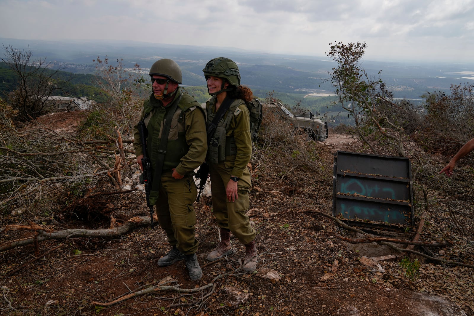 Israeli soldiers display what they say is an entrance to a Hezbollah tunnel found during their ground operation in southern Lebanon, near the border with Israel, Sunday, Oct. 13, 2024. (AP Photo/Sam McNeil)