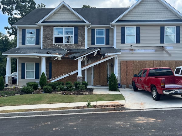 The Hiram-area home remained boarded up on Monday following the fatal shooting of Paulding County Deputy Brandon Cunningham