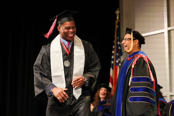 Herschel Walker (left) participated in the  University of Georgia graduation ceremony for the College of Family and Consumer Sciences last week.