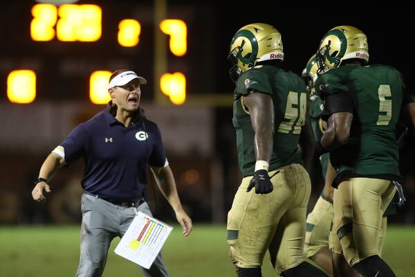 Sept. 18, 2020 - Loganville, Ga: Grayson head coach Adam Carter celebrates with Tyzen Wilkerson (58) and Jaidan Jackson (5) in the second half against Collins Hill at Grayson High School Friday, September 18, 2020 in Loganville, Ga.. Grayson won 28-7. This is a game between two top ranked teams in GeorgiaÕs highest classification of high school football. In Class 7A Grayson is ranked #1 and Collins Hill is ranked #6. JASON GETZ FOR THE ATLANTA JOURNAL-CONSTITUTION