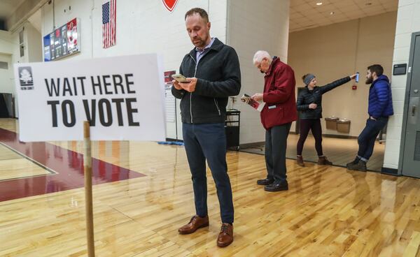 Secretary of State Brad Raffensperger on Thursday postponed Georgia’s primary election for another three weeks, until June 9, as the coronavirus spreads.  Grant Jones is seen here voting at Henry W. Grady High School in December 2018. JOHN SPINK / JSPINK@AJC.COM