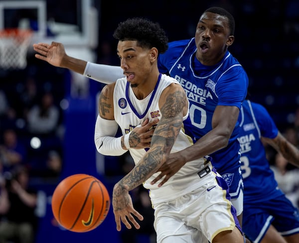 James Madison guard Terrence Edwards Jr., left, is defended by Georgia State forward Jay'Den Turner during the second half of an NCAA college basketball game in Harrisonburg, Va., Thursday, Feb. 15, 2024. (Daniel Lin/Daily News-Record via AP)