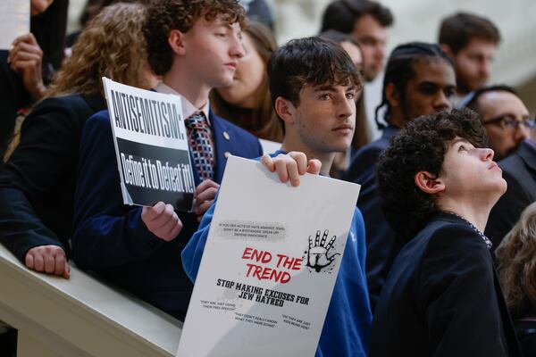 Members of the Jewish community and supporters hold signs during a press conference in February at the Georgia Capitol to promote legislation that would make antisemitism part of Georgia's hate crimes law. The bill cleared the Georgia House during the 2023 legislative session but stalled in the state Senate. (Natrice Miller/ natrice.miller@ajc.com) 