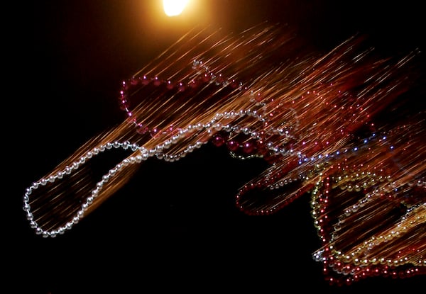 FILE - Beads are flying during a Mardi Gras parade in Metarie, La., Wednesday Feb. 22, 2006. (AP Photo/Alex Brandon, File)