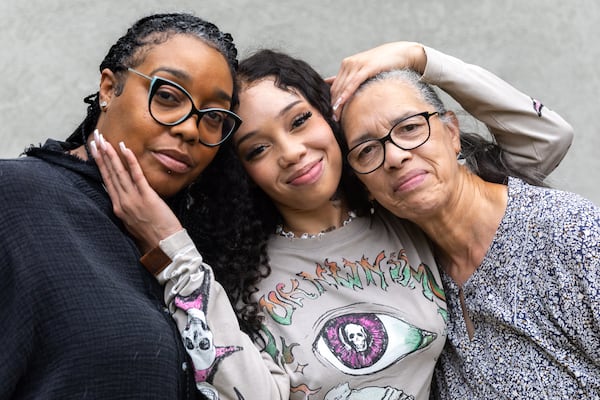 Atlanta rapper Anycia (center) and her mother Andrea  (left) and grandmother Narvellette (right) at their family home in metro Atlanta.  (Arvin Temkar / AJC)