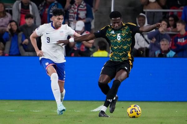 Jamaica's Di'Shon Bernard (6) and United States' Ricardo Pepi (9) chase after a loose ball during the first half in a CONCACAF Nations League quarterfinal second leg soccer match Monday, Nov. 18, 2024, in St. Louis. (AP Photo/Jeff Roberson)