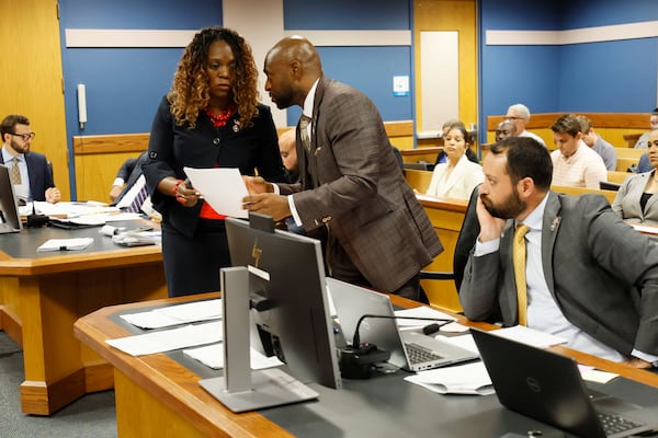 Special Prosecutor Nathan Wade and  Daysha D'Anya Young, representing the District Attorney's office, confer as they argue argue before Fulton County Superior Judge Scott McAfee. McAfee is hearing motions from attorneys representing Kenneth Chesebro and Sidney Powell on Thursday, Sept. 14, 2023.
Miguel Martinez /miguel.martinezjimenez@ajc.com