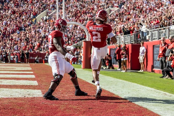 Alabama offensive lineman Elijah Pritchett (57) and wide receiver Ryan Williams (2) celebrate William's first touchdown of the game during the first half of an NCAA college football game against Mercer, Saturday, Nov. 16, 2024, in Tuscaloosa, Ala. (AP Photo/Vasha Hunt)