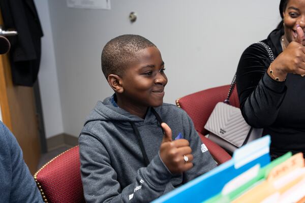 Nathan Mandeng, 11, from Cameroon, gives a thumbs-up to indicate that he is ready for his preliminary exam at Gwinnett County Public Schools' International Welcome Center in Lawrenceville on Monday, Oct. 9, 2023. (Olivia Bowdoin for The Atlanta Journal-Constitution)