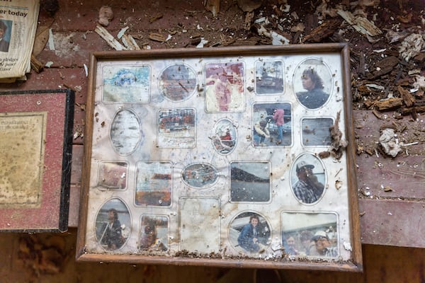 Old photos are seen inside the circa 1840 Power-Jackson Cabin in Marietta on Monday, December 4, 2023. The Cobb Landmarks + Historical Society hopes to restore and move the building. (Arvin Temkar / arvin.temkar@ajc.com)