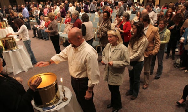 Participants wait in line during the annual New Year's Eve Burning Bowl service at Unity North Atlanta Church in Marietta Saturday, Dec. 31, 2010. The ceremony is completed on New Year's Eve. Each participant writes down the things, experiences, conflicts, or unhappiness of the past year they wish to release to God through fire. Participants place their lists into the sacred fire. This ritual creates the space within needed for the new.