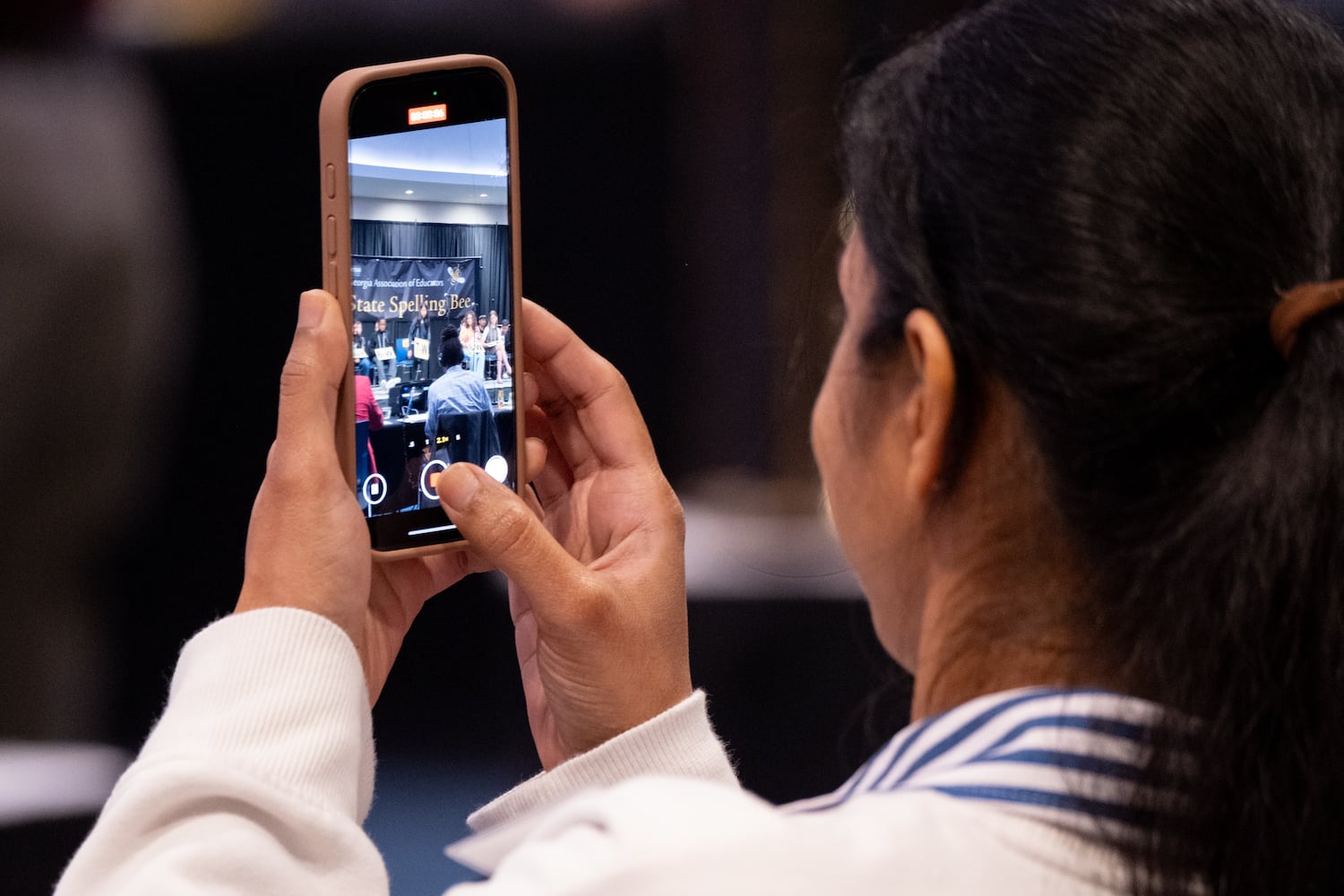 A parent takes a photo during the practice round of the GAE State Spelling Bee Championship at Georgia State University in Atlanta on Friday, March 21, 2025.   Ben Gray for the Atlanta Journal-Constitution