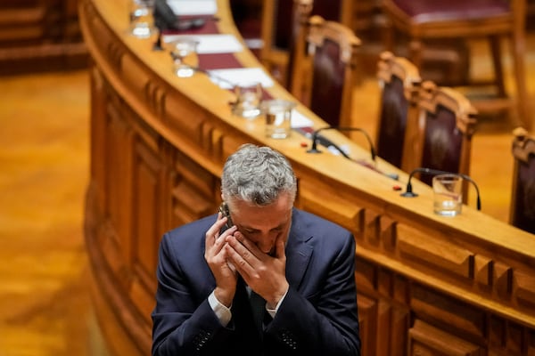 Portuguese Socialist party secretary general Pedro Nuno Santos speaks on the phone during a break in a debate preceding a vote of confidence concerning Portuguese Prime Minister Luis Montenegro at the Portuguese parliament in Lisbon, Tuesday, March 11, 2025. (AP Photo/Armando Franca)