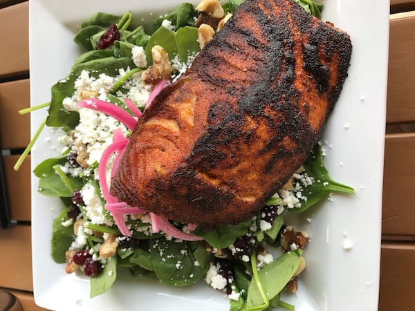 Grilled Faroe Island salmon over a spinach salad at Volare Bistro in Hapeville. LIGAYA FIGUERAS / LFIGUERAS@AJC.COM