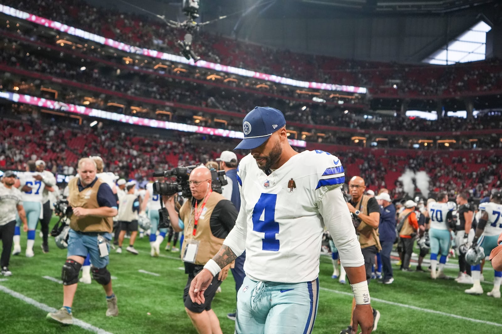 Dallas Cowboys quarterback Dak Prescott (4) walks off the field after an NFL football game against the Atlanta Falcons, Sunday, Nov. 3, 2024, in Atlanta. The Falcons won 27-21. (AP Photo/ Brynn Anderson)