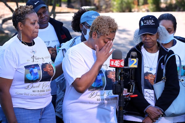 020922 ATLANTA: David Mack's aunts Ayana Riley (from left), Radiah Allen, and grandmother Glenda Mack become emotional during a press conference by the family looking for answers a year after his murder on Wednesday, Feb. 9, 2022, in Atlanta. David Mack, 12, disappeared, after saying he was going to visit a friend. The next day, his body was found along the concrete slope of Utoy Creek in some woods near his home. David’s grieving family is sure there is someone out there who could come forward to help them find out who shot and killed him, and why.
  “Curtis Compton / Curtis.Compton@ajc.com”`