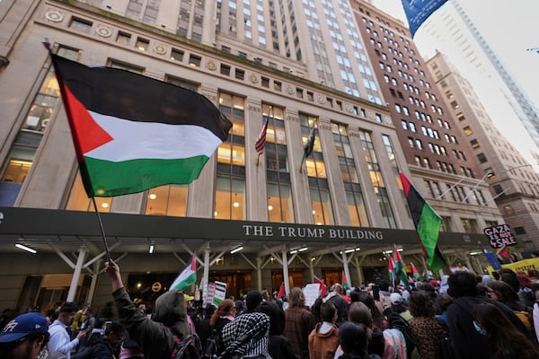 People gather to protest against Israel and President Donald Trump in front of a Trump-branded building Wednesday, March 19, 2025, in New York. (AP Photo/Frank Franklin II)