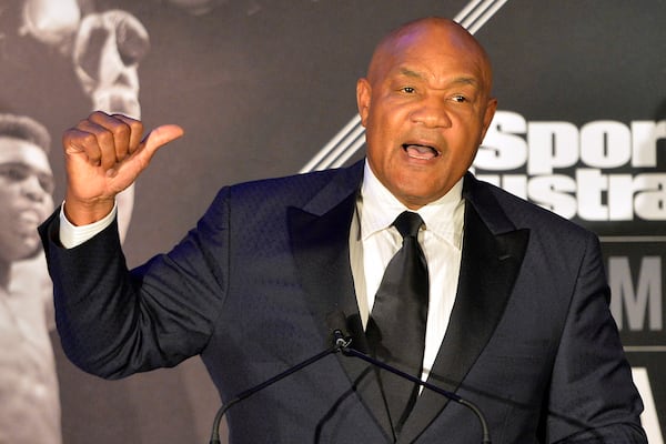 FILE - Former heavyweight boxing champion George Foreman tells a story to the audience at the Sports Illustrated Legacy Awards, Oct. 1, 2015, in Louisville, Ky. (AP Photo/Timothy D. Easley, File)