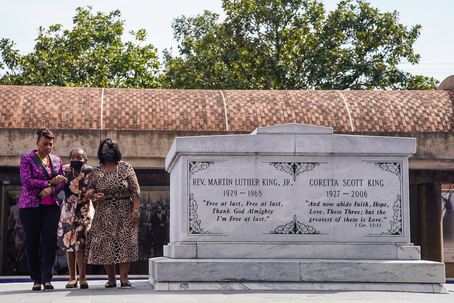 Christine King Farris, eldest sibling of Dr. Margin Luther King Jr., center, is led by Bernice A. King, left, CEO of The King Center, and another member of the King family, at a wreath laying ceremony at The King Center on the 54th anniversary of the assassination of Dr. Martin Luther King Jr., on Monday, April 4, 2022, in Atlanta. (Elijah Nouvelage/Special to the Atlanta Journal-Constitution)